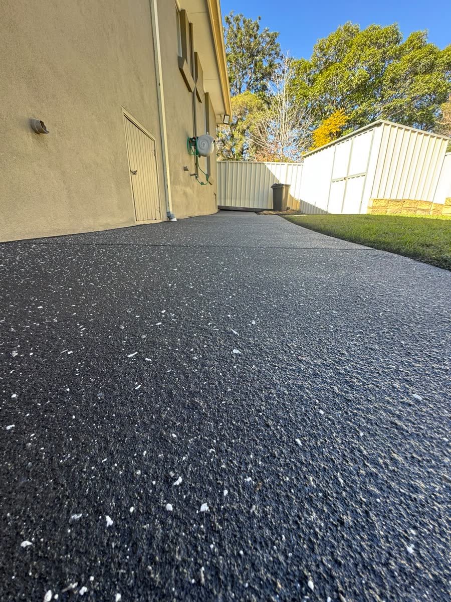 Spray-crete driveway along the side of the house by Epoxy Flooring NSW