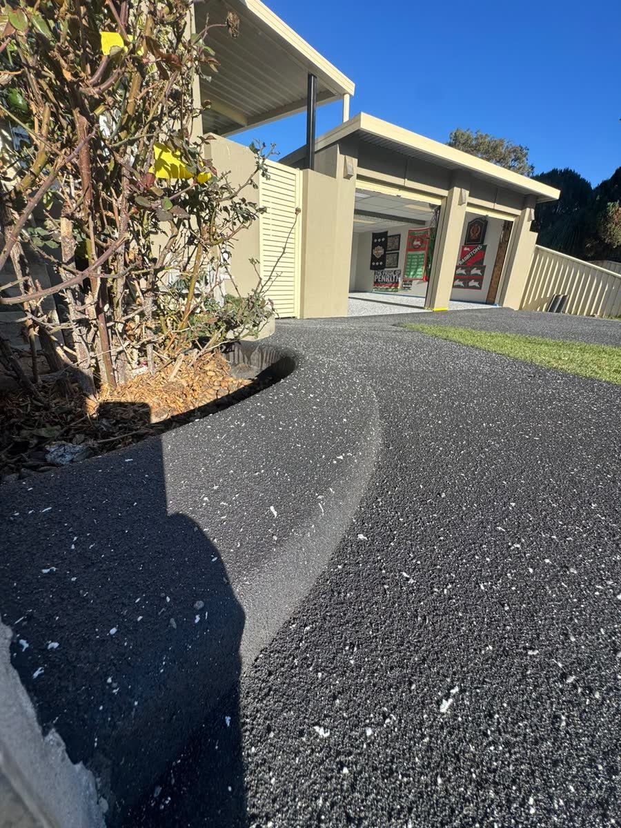 Curved charcoal spray-crete driveway by Epoxy Flooring NSW