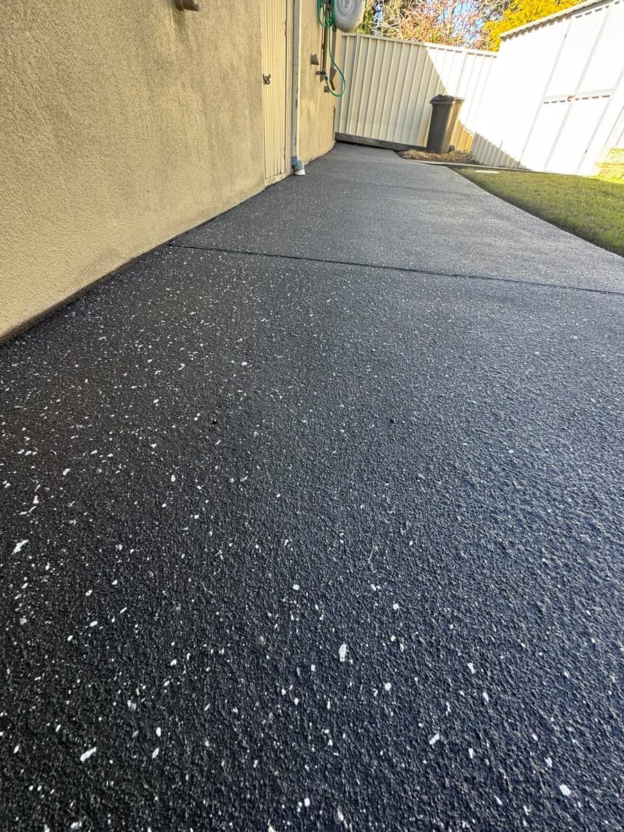 Spray-crete driveway along the side of the house by Epoxy Flooring NSW